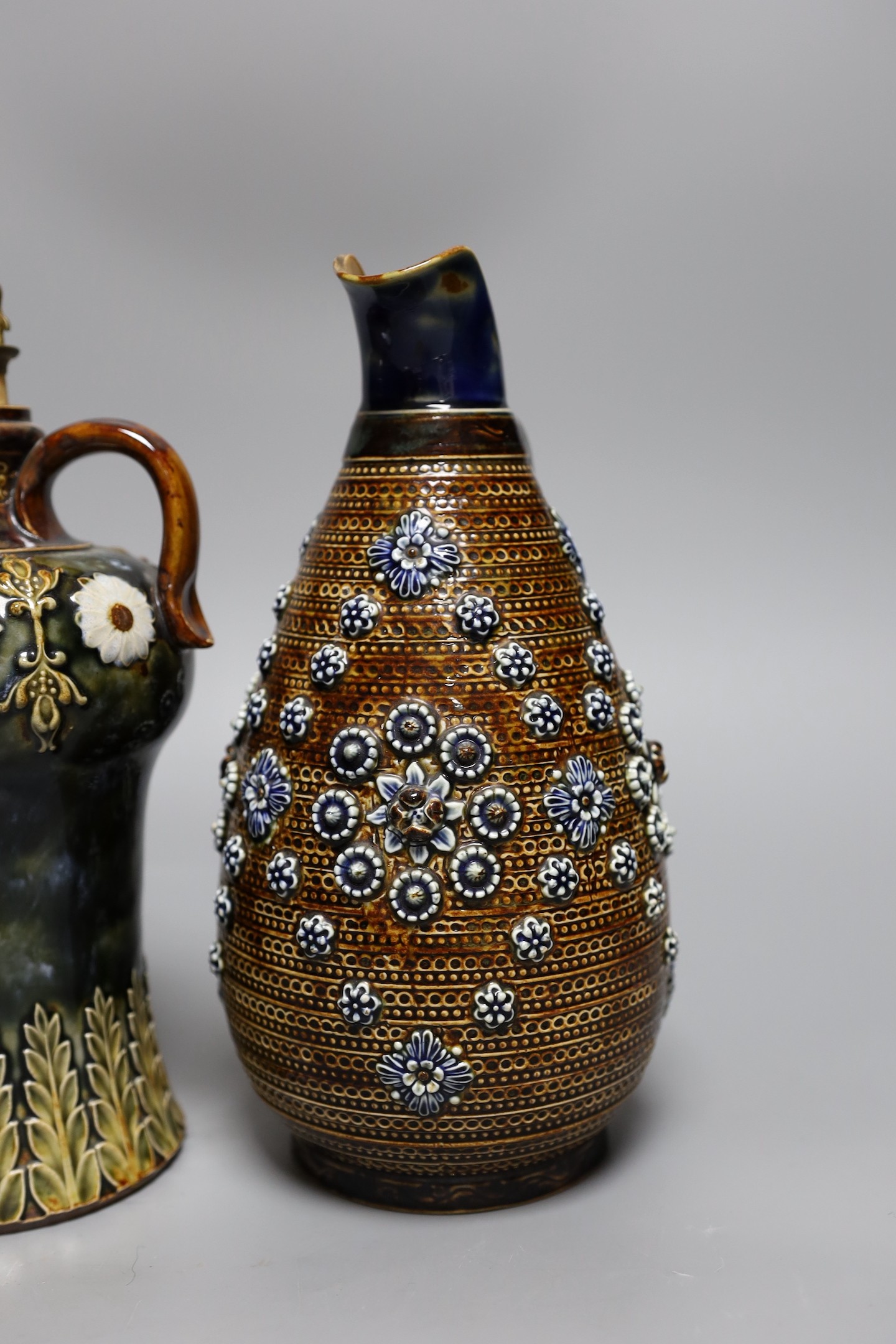 A Doulton Lambeth stoneware decanter and a similar jug, dated 1877, jug 24cms high